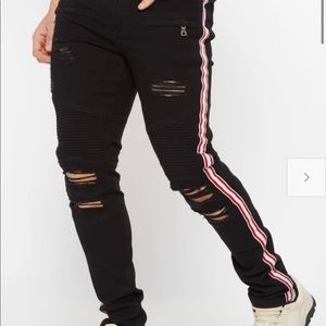 Black ripped jeans with red stripe